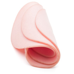 cooked boiled ham sausage or rolled bologna slices isolated on w © Natika
