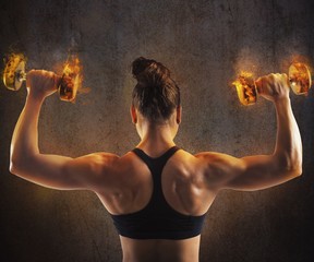 Woman training with  fiery dumbbells