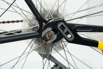 Man Tightening The Bolts Of Bicycle Seat