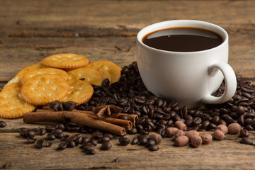 Cup of coffee on a wooden board and biscuits
