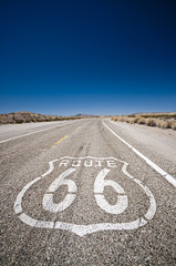 Route 66 pavement sign with Mojave desert 