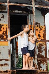 two boys stand in the old train