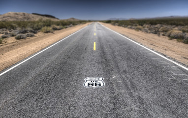 Route 66 pavement sign with Mojave desert 