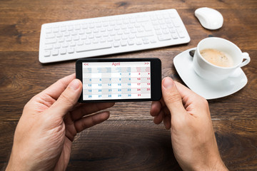 Person Hands With Mobile Phone Showing Calendar