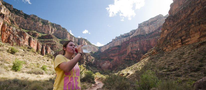 Young woman drinking water while hiking in Grand Canyon National Park, USA