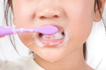 Little asian girl brush teeth