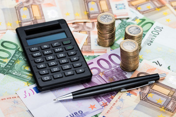Calculator And Pen On Euro Currency