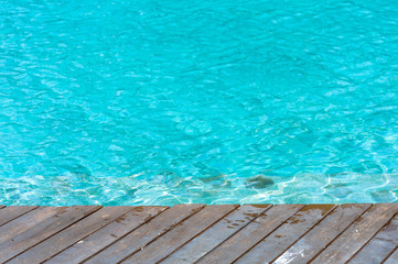 Focus on Wood floor beside the pool