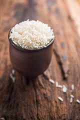 Raw rice in ceramic bowl