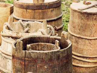 A lot of old wooden buckets and barrels taken closeup.