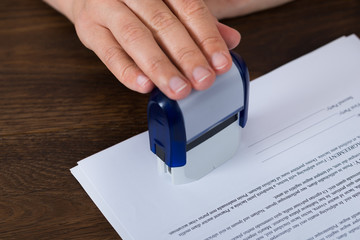 Person Hands Stamping Document