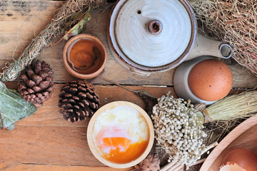 soft-boiled egg and eggs on wood background
