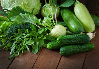 Useful green vegetables on a wooden background