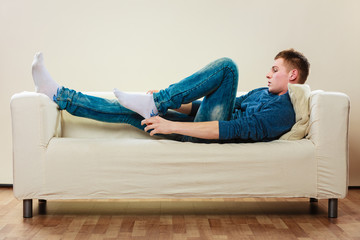 Young man relaxing on couch