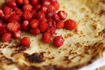 Pancakes with red fresh forest wild strawberry