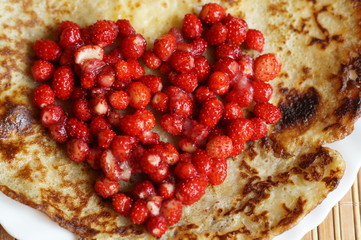 Pancakes with red fresh forest wild strawberry heart