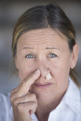 Stressed woman with nose plug