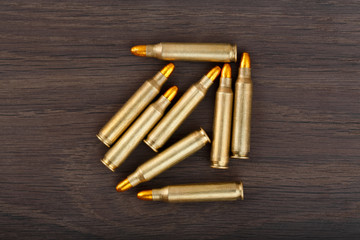 Fire arm bullet cartridges on a old wooden floor.