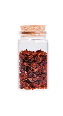 Dried barberries in a glass bottle with cork stopper, isolated o