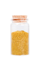 A handful of dried seasonings hops-suneli in a glass bottle with