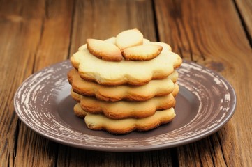 Round wavy sand cakes in pile decorated with small cakes on brow