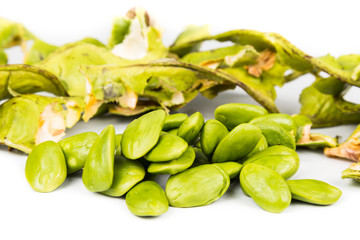 Petai seeds with the its skin, seed pods and cluster at background