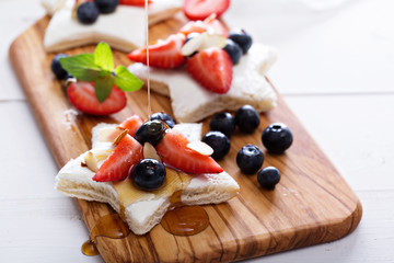 Star shaped sandwiches with berries and cheese