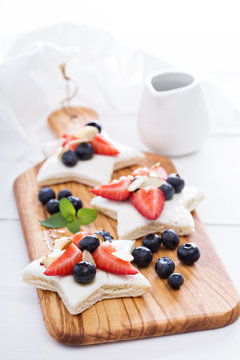 Star shaped sandwiches with berries and cheese