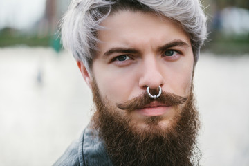 Bearded hipster with nose ring in leather jacket - 86371946