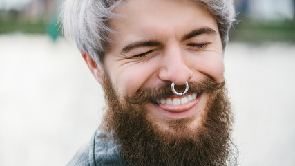Bearded hipster with nose ring in leather jacket - 86371957