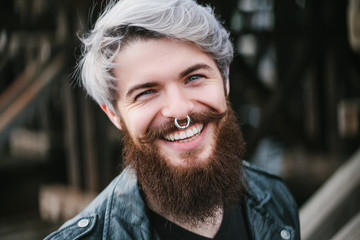 Bearded hipster with nose ring in leather jacket - 86371967