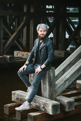 Fototapeta na wymiar Bearded hipster with nose ring in leather jacket