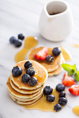 Stack of small pancakes with berries