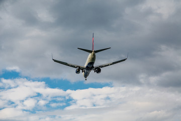 Fototapeta na wymiar Jet Airliner Heading Toward Clouds