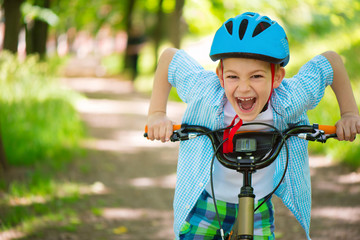 Fototapeta na wymiar Cute little boy on bike