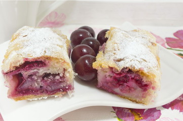 Homemade cherry pie covered with sugar and decorated with raw ch