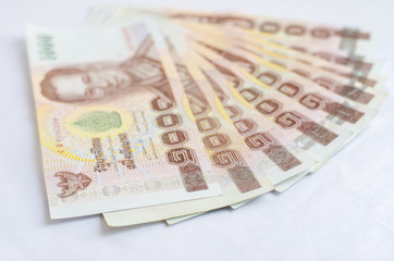 Close up of one thousand Thailand bath banknotes on white backgr