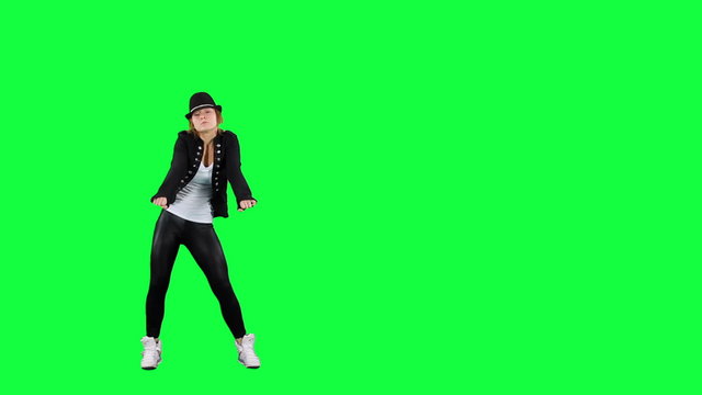 Girl in the hat dancing like the king of pop. Chroma key background. Young woman dancing against a green background
