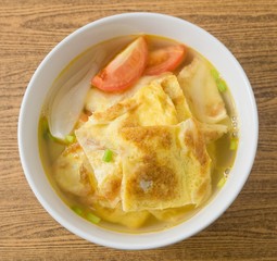 Top View of Thai Omelet Soup with Tomatoes and Scallion