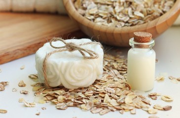 handmade soap bar oatmeal milk natural organic domestic skincare cosmetics, white towel, wooden utensils