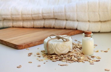 Fototapeta na wymiar handmade soap bar oatmeal milk natural organic domestic skincare cosmetics, white towel, wooden utensils