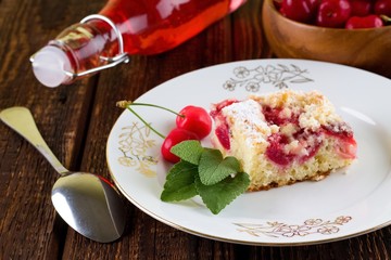 Four herb leaves on plate with cherry pie