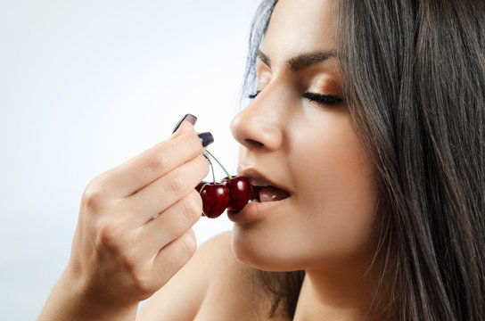 beautiful sexy girl eats cherry