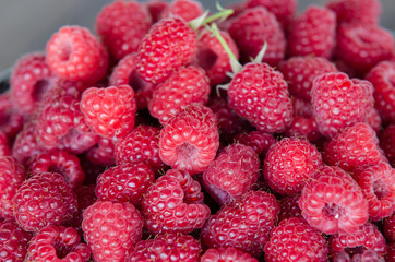 fresh ripe raspberries in clay plate