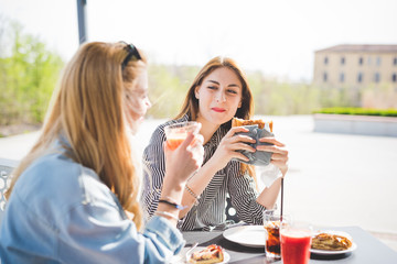 Young beautiful friends having an happy hour