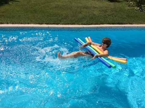 Frau schwimmt entspannt im Pool