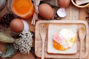 soft-boiled egg with bread on wood background.