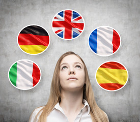 Beautiful lady is surrounded by bubbles with european countries' flags (Italian, German, Great...