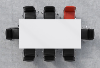 Top view of a conference room. A white rectangular table and eight chairs around, one of them is...