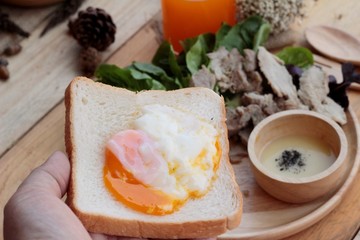 soft-boiled egg on toast with sliced pork tenderloin.
